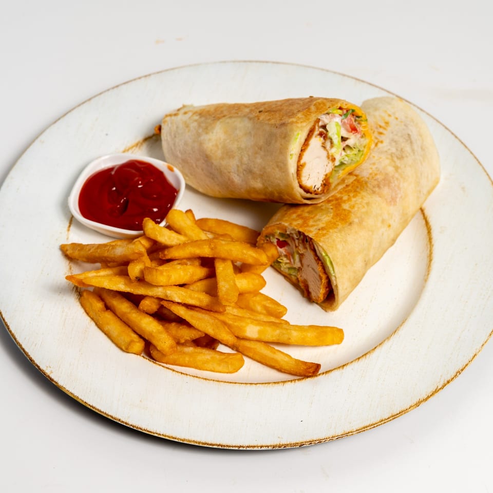 Two fried chicken wraps with fries and a side of ketchup on a white plate.