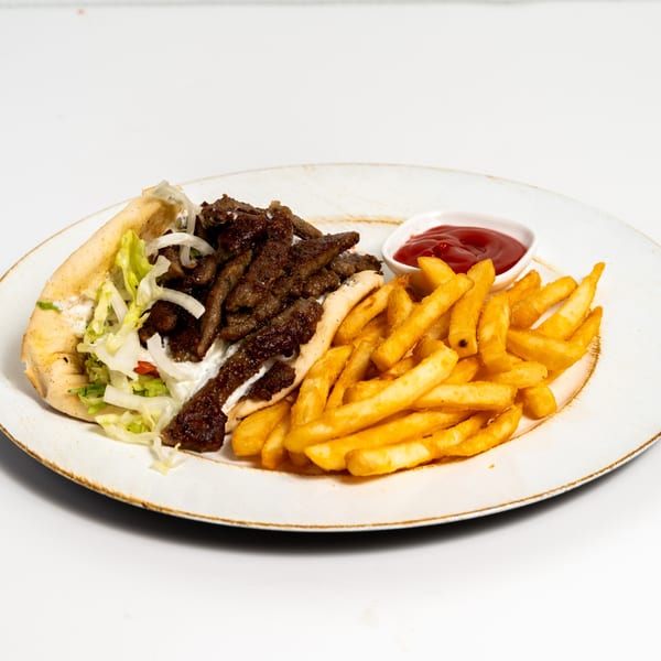 A US Fried Chicken gyro with meat, lettuce, onions, and sauce, served with golden fries and ketchup.