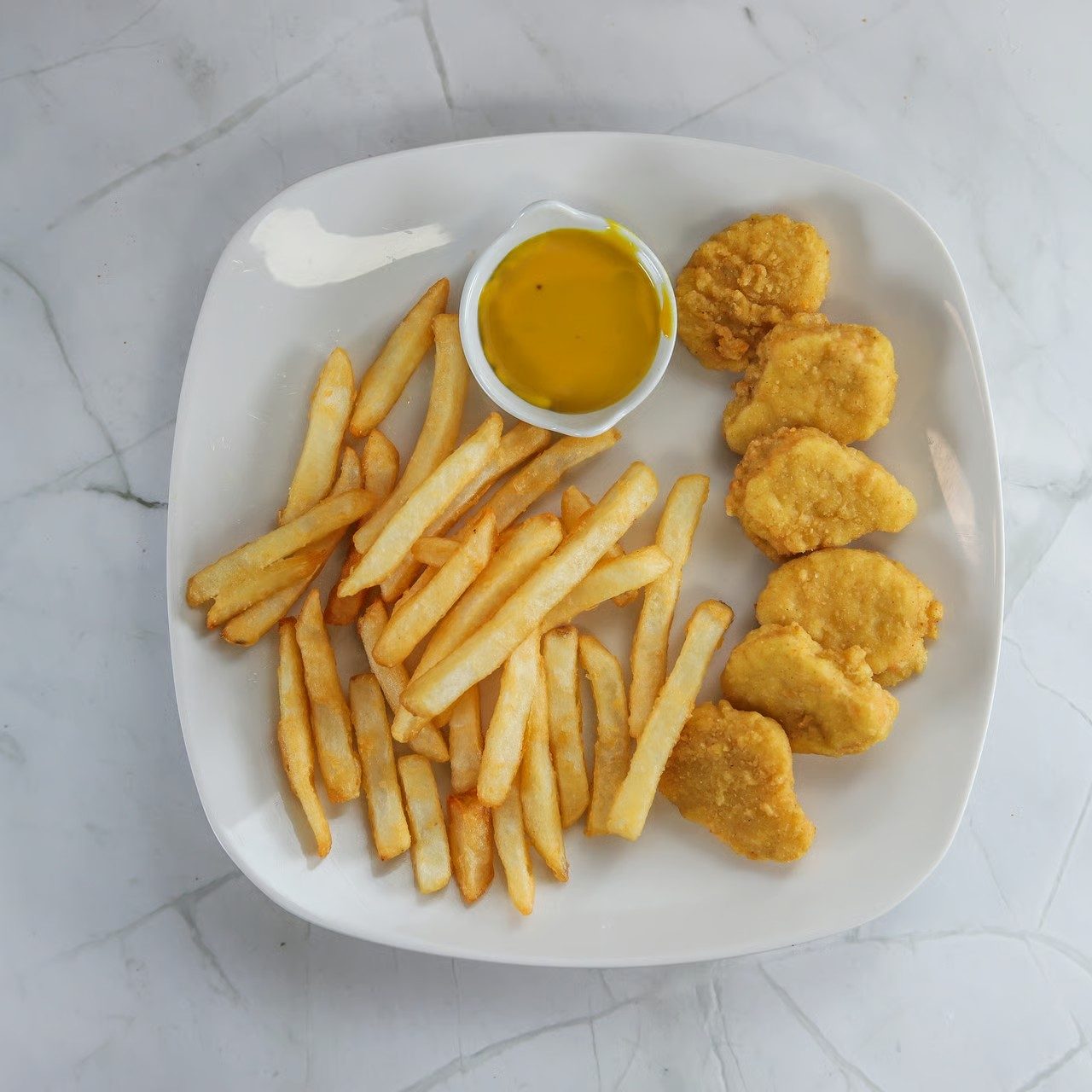 Kids nuggets with fries.